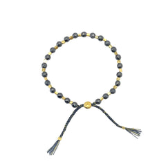 smr // hematite metallic black with yellow gold // Signature Collection bracelet